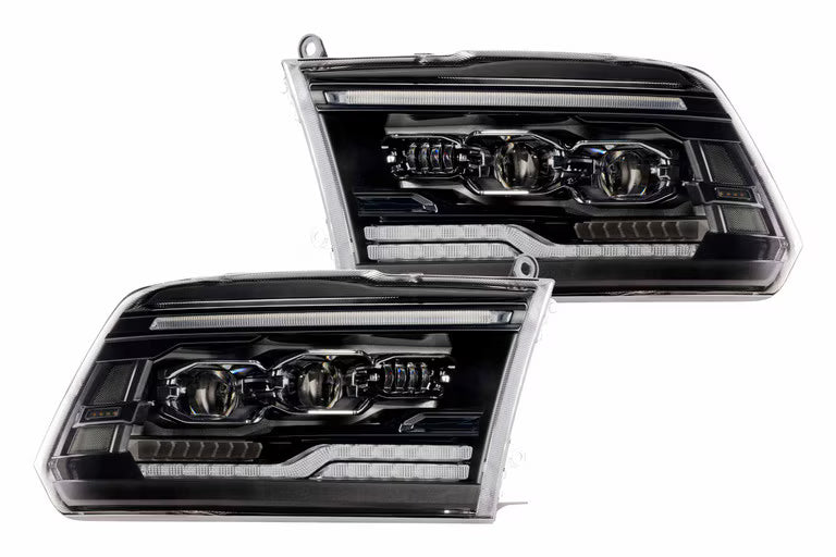 Pair of black in housed Truck headlights with a white background