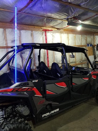 Polaris ATV with LED whip light installed, parked in a garage, LynXautoinnovate automotive accessory