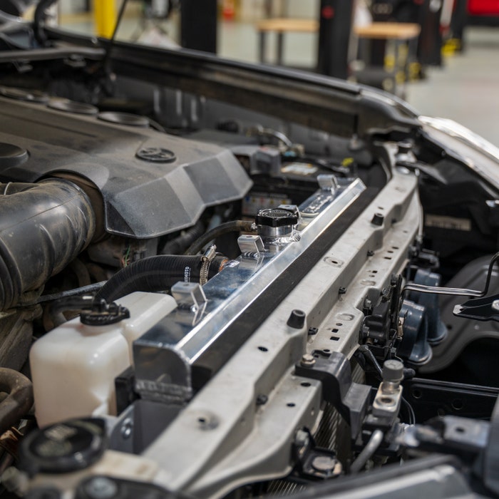 Close-up of automotive engine bay with aftermarket aluminum radiator, LynXautoinnovate™ USA auto parts