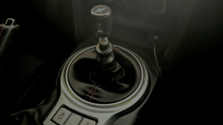 Manual car gear shifter with stitched leather boot in vehicle interior, LynXautoinnovate automotive parts