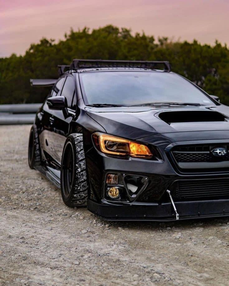 Modified black Subaru car with custom wheels and LED headlights, outdoor setting, LynXautoinnovate automotive parts.