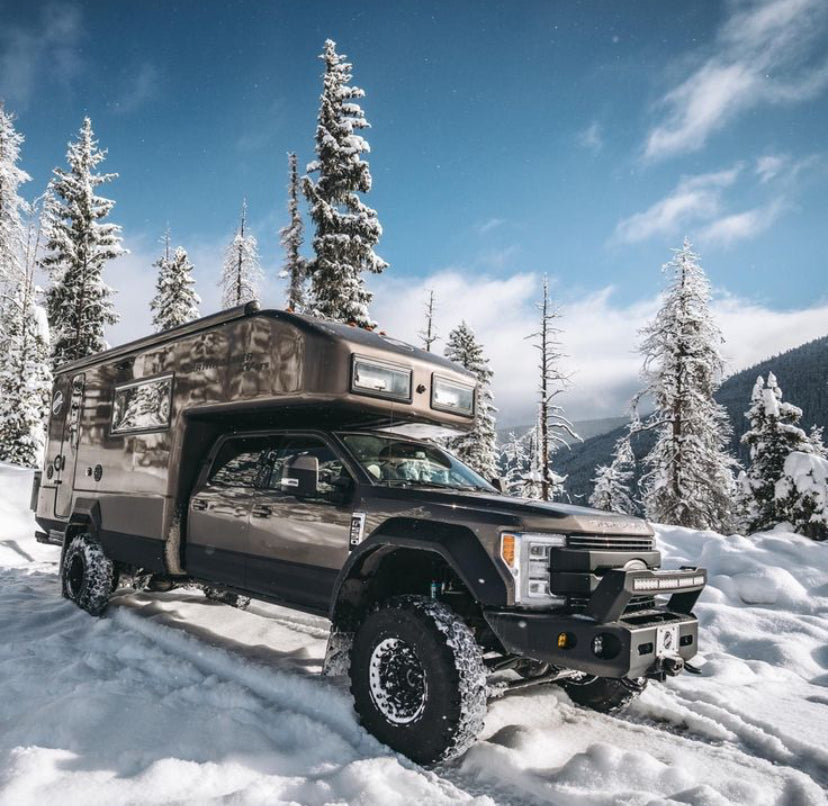 Off-road truck camper with snow tires in a snowy forest, LynXautoinnovate automotive parts USA