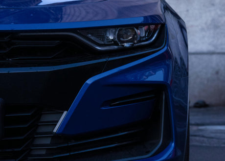 Close-up of blue sports car front bumper and headlight, LynXautoinnovate automotive parts USA