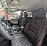 Car interior with quilted gray seats and dashboard.