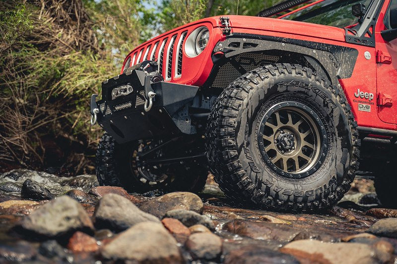 Red Jeep along a river side 