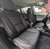 Car interior with quilted gray seats and visible dashboard.
