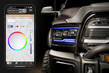 Smartphone displaying a lighting control app next to a vehicle with illuminated headlights.