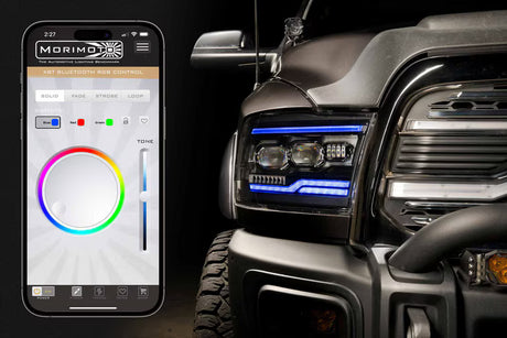 Smartphone displaying a lighting control app next to a vehicle with illuminated headlights.