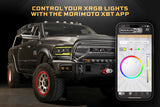 Black off-road vehicle with Morimoto XRGB lights and a smartphone displaying the XBT app.