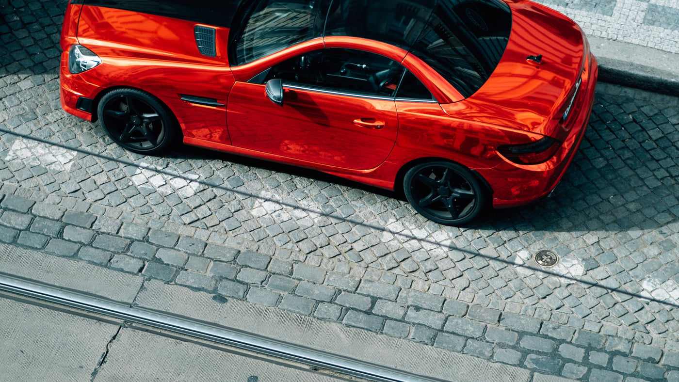 red-car-with-a-black-roof-parked-on-the-side-of-a-road - LynXautoinnovate®