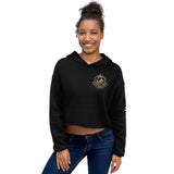 Woman wearing black LynXautoinnovate cropped hoodie with gold automotive logo, front view